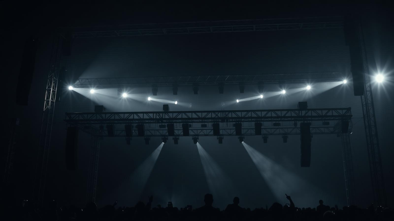 Concert production rig at night with stage lighting trusses